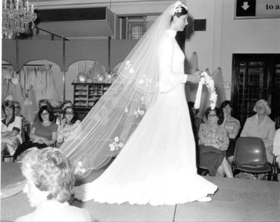  Models wearing bridal gown on the catwalk at a fashion show for Dickins and Jones, c.1960s.